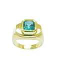 Men's 14K yellow gold ring with a rectangular bluish-green Muzo Colombian emerald.