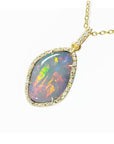 4.30 ct. natural Australian opal pendant with fiery red-orange play-of-color, halo diamonds, and 18K yellow gold chain.