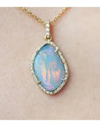 4.30 ct. natural Australian opal pendant with fiery red-orange play-of-color, halo diamonds, and 18K yellow gold chain.
