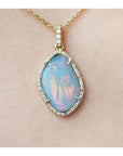 4.30 ct. natural Australian opal pendant with fiery red-orange play-of-color, halo diamonds, and 18K yellow gold chain.