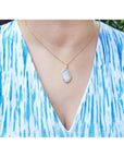 4.30 ct. natural Australian opal pendant with halo diamonds on an 18K yellow gold chain.