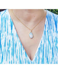 4.30 ct. natural Australian opal pendant with halo diamonds on an 18K yellow gold chain.