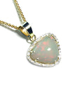Triangular Australian white opal pendant with red fire, diamond halo, and 14K yellow gold chain.