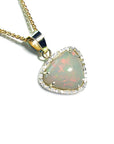 Triangular Australian white opal pendant with red fire, diamond halo, and 14K yellow gold chain.