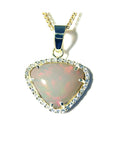 Trillion-cut Australian white opal pendant with red fire, diamond halo, and 14K yellow gold chain.