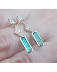 14K gold baguette cut emerald drop earrings with sparkling diamonds.