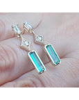 14K gold baguette cut emerald drop earrings with sparkling diamonds.