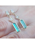 14K gold baguette cut emerald drop earrings with sparkling diamonds.