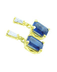 14K yellow gold blue sapphire emerald cut dangle earrings with tapered baguette diamonds.