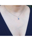 1.05 carat natural blue sapphire necklace in 14K white gold, with a trillion diamond centerpiece.