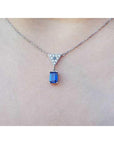 1.05 carat natural blue sapphire necklace in 14K white gold with a trillion diamond centerpiece.