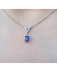1.05 carat natural blue sapphire necklace in 14K white gold with a trillion diamond centerpiece.