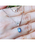 1.05 carat natural blue sapphire necklace in 14K white gold with a trillion diamond centerpiece.
