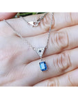 1.05 carat natural blue sapphire necklace in 14K white gold with a trillion diamond centerpiece.