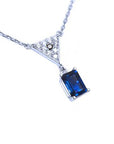 Right side top view of a natural blue sapphire necklace with diamonds 14k white gold dangling pendant