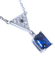 Right side profile view of a natural blue sapphire necklace with diamonds 14k white gold dangling pendant