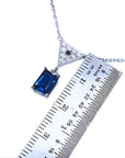 1.05 carat natural blue sapphire necklace in 14K white gold with a trillion diamond pendant.