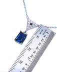 1.05 carat natural blue sapphire necklace in 14K white gold with a trillion diamond pendant.