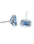 Emerald cut natural blue sapphire stud earrings with diamond halo in 14K white gold.