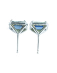 Emerald cut natural blue sapphire stud earrings with diamond halo in 14K white gold.