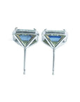 Emerald cut natural blue sapphire stud earrings with diamond halo in 14K white gold.