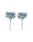 Emerald cut natural blue sapphire stud earrings with diamond halo in 14K white gold.