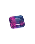 Faceted natural watermelon tourmaline with pink and blue colors on a white background.