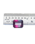 Natural 3.55 ct. watermelon tourmaline, vibrant red and greenish-blue, emerald cut, next to a ruler.
