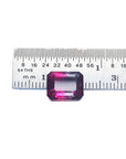 Natural 3.55 ct. watermelon tourmaline, vibrant red and greenish-blue, emerald cut, next to a ruler.