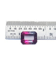 Natural 3.55 ct. watermelon tourmaline, vibrant red and greenish-blue, emerald cut, next to a ruler.