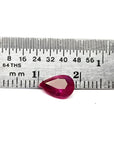 1.24 carat natural Burmese ruby, pear cut, brilliant medium red, shown next to a ruler.