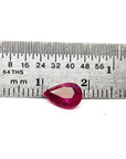 Natural burmese loose ruby pear cut, front side table and crown are visibles on a ruler for scale
