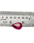 1.24 carat natural Burmese ruby, pear cut, brilliant medium red, shown next to a ruler.