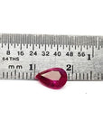 1.24 carat natural Burmese ruby, pear cut, brilliant medium red, shown next to a ruler.