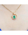 14k yellow gold necklace with oval natural Colombian emerald and diamond accents.