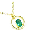14k yellow gold necklace with a natural oval cut colombian emerald and diamonds.