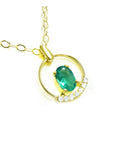 14k yellow gold necklace with a natural oval cut colombian emerald and diamonds.