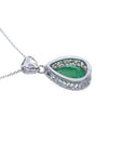 Back view of a pear-cut Colombian emerald pendant in 18K white gold with intricate filigree.
