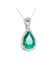 5.83 ct. Colombian emerald pear cut pendant with diamond halo in 18K white gold.
