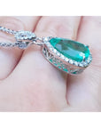 5.83 ct. Colombian emerald pear cut pendant with diamond halo, set in 18K white gold.