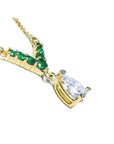14K gold necklace with a 0.69 ct pear diamond and seven round emeralds in a V-shape.
