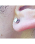 Sparkling 0.51 ct natural diamond stud earring with 14K white gold six-prong setting and screw back on an ear.