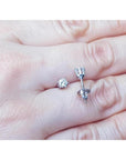 Pair of 14K white gold natural diamond stud earrings with six-prong settings and screw backs.