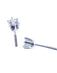 A pair of a 14k white gold diamond stud earrings, underside profile view.