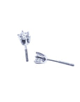 A pair of a 14k white gold diamond stud earrings, underside profile view.