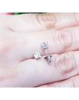 0.46 ct natural diamond stud earrings with screw backs, set in 14K white gold on a hand.