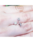 0.46 ct natural diamond stud earrings with screw backs, set in 14K white gold on a hand.