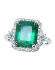 This emerald-cut with a halo diamond emerald ring crafted in white gold, is on a front position full top view.
