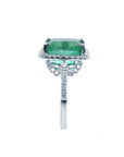 A white gold emerald engagement ring displaying the top, gallery sides and shank profile.