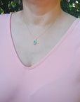 Ladies' Colombia emerald necklace square emerald-cut sourced from the Muzo mine, weighing 0.98 carats, halo diamond 14k gold